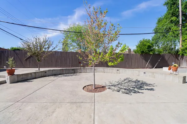 a backyard of a house with table and chairs