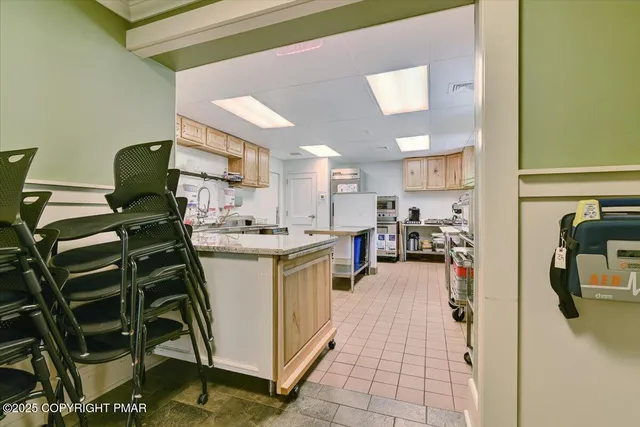 a kitchen with a sink appliances and cabinets