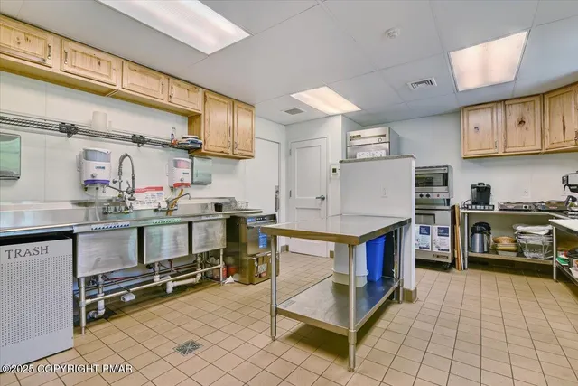 a kitchen with stainless steel appliances a stove a sink and a refrigerator