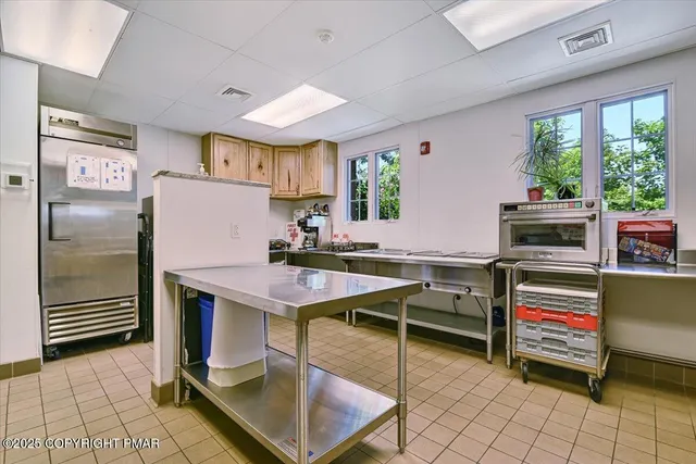 a room with furniture a flat screen tv and windows