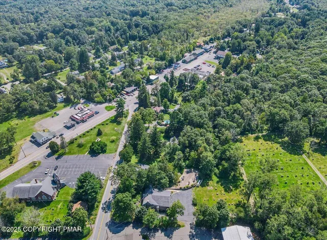 an aerial view of a house with garden space and street view