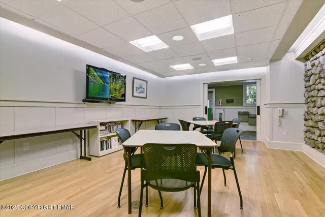 a view of a dining room with furniture and wooden floor