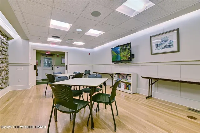 a view of a dining room with furniture and wooden floor