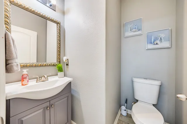 a bathroom with a toilet sink and mirror