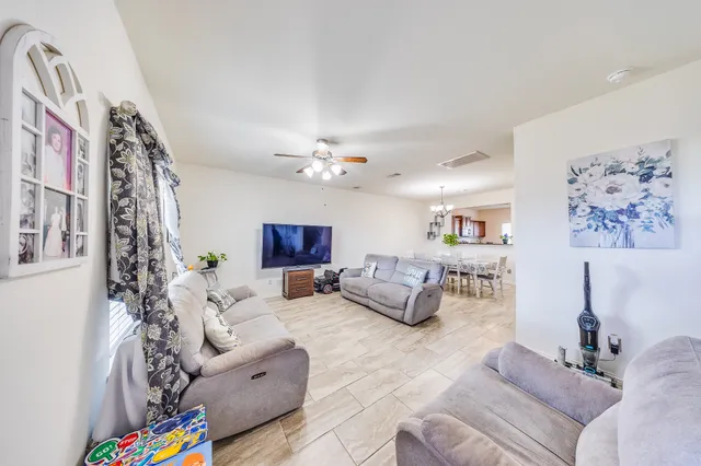 a living room with furniture and a chandelier