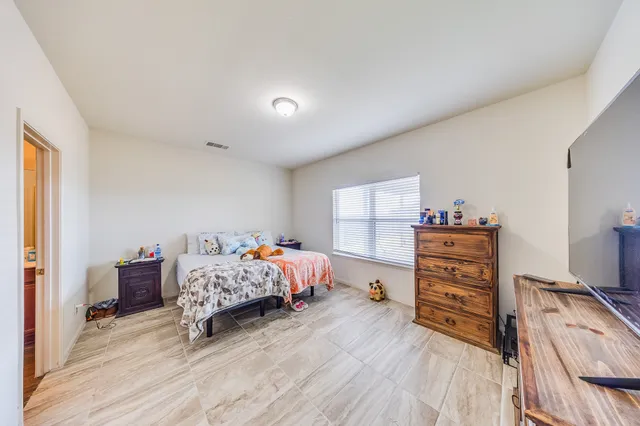 a bedroom with furniture and a wooden floor