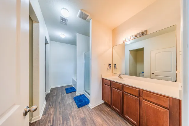 a spacious bathroom with a double vanity sink and a mirror