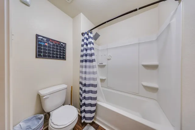 a bedroom with bed and a chandelier