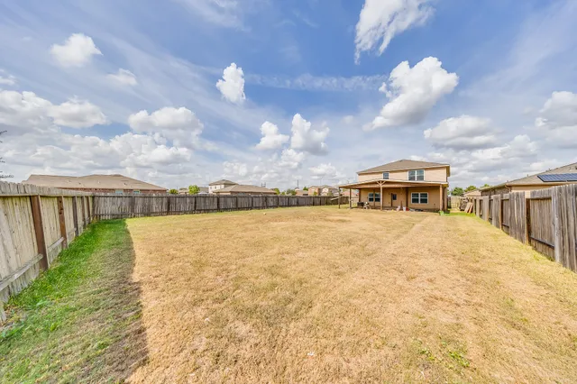 a view of a house with wooden fence