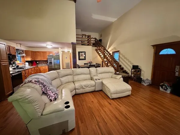 a living room with furniture and a wooden floor