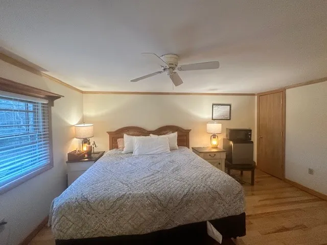 a bedroom with a bed and lamps