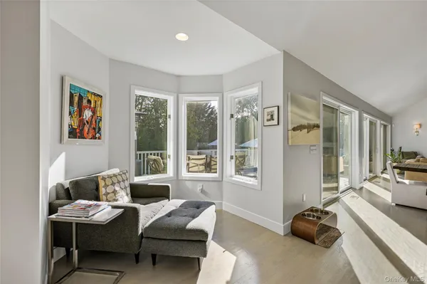 a bedroom with furniture and a large window