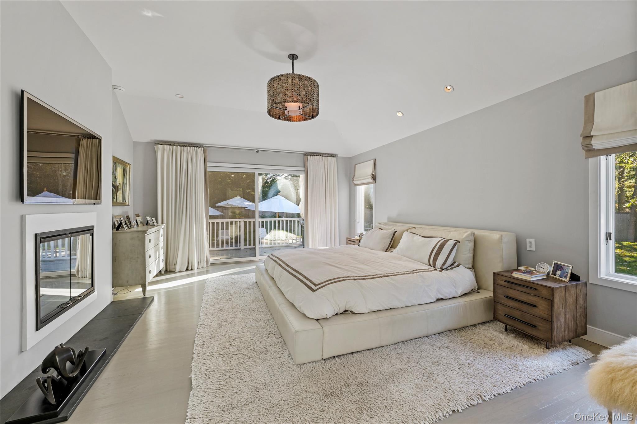 6 Bridle Path Westhampton Beach, NY 11978 - Photo 13 of 33 a spacious bedroom with a bed and a flat tv screen