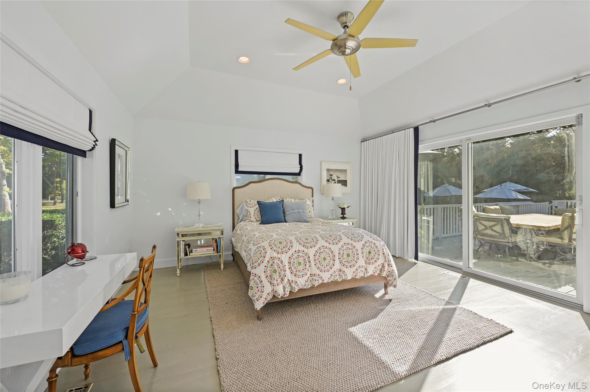 6 Bridle Path Westhampton Beach, NY 11978 - Photo 15 of 33 a bedroom with a bed a chandelier and a window