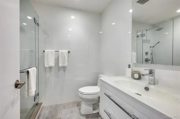 a bathroom with a sink toilet a shower and a mirror