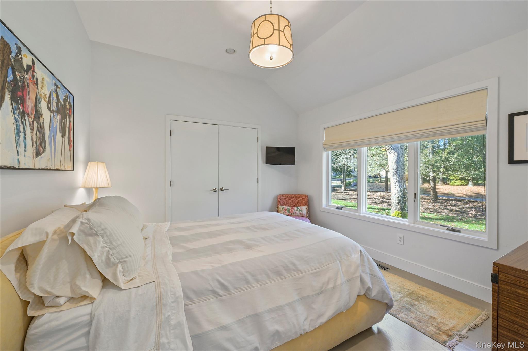 6 Bridle Path Westhampton Beach, NY 11978 - Photo 17 of 33 a bedroom with a bed and a window