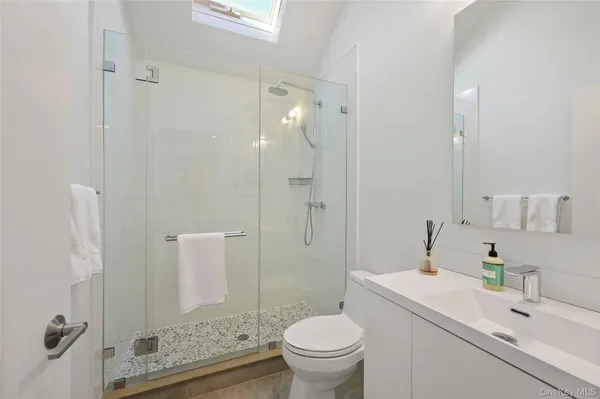 a bathroom with a sink toilet and shower