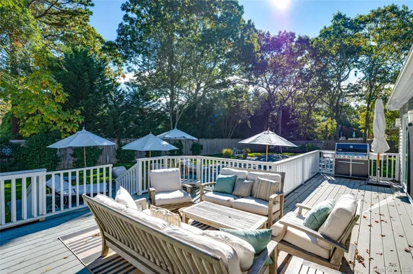a roof deck with a table and chairs