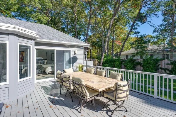 a view of a patio with table and chairs floor to ceiling window with wooden floor