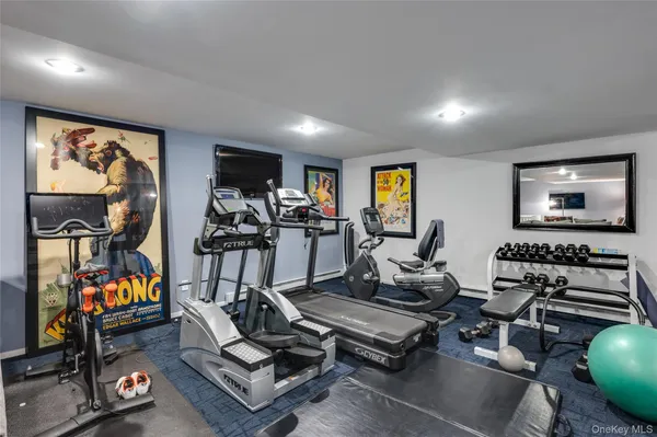 a room with gym equipment and a flat screen tv