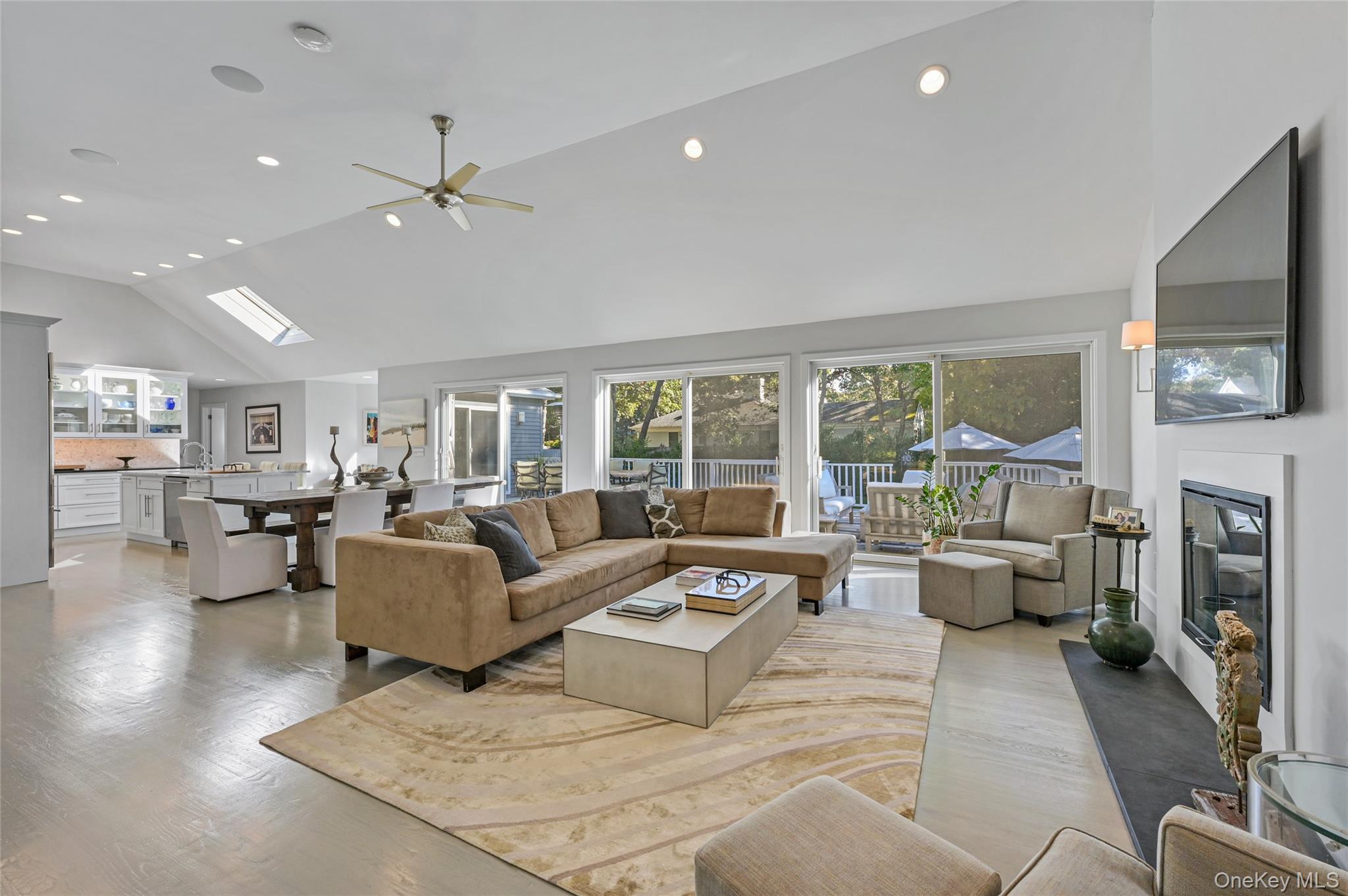 6 Bridle Path Westhampton Beach, NY 11978 - Photo 3 of 33 a living room with fireplace furniture and a flat screen tv