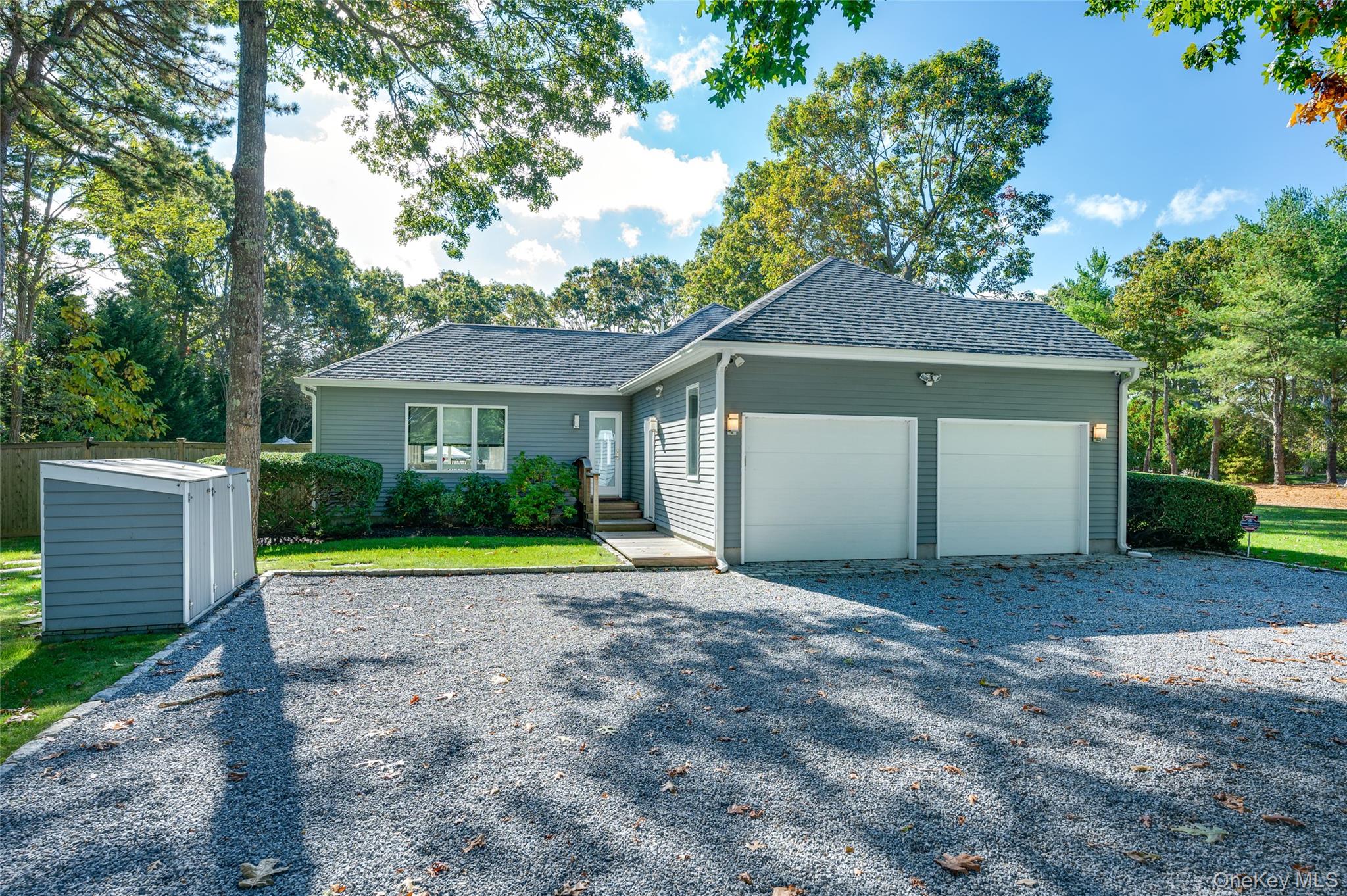 6 Bridle Path Westhampton Beach, NY 11978 - Photo 32 of 33 a front view of a house with a yard and garage
