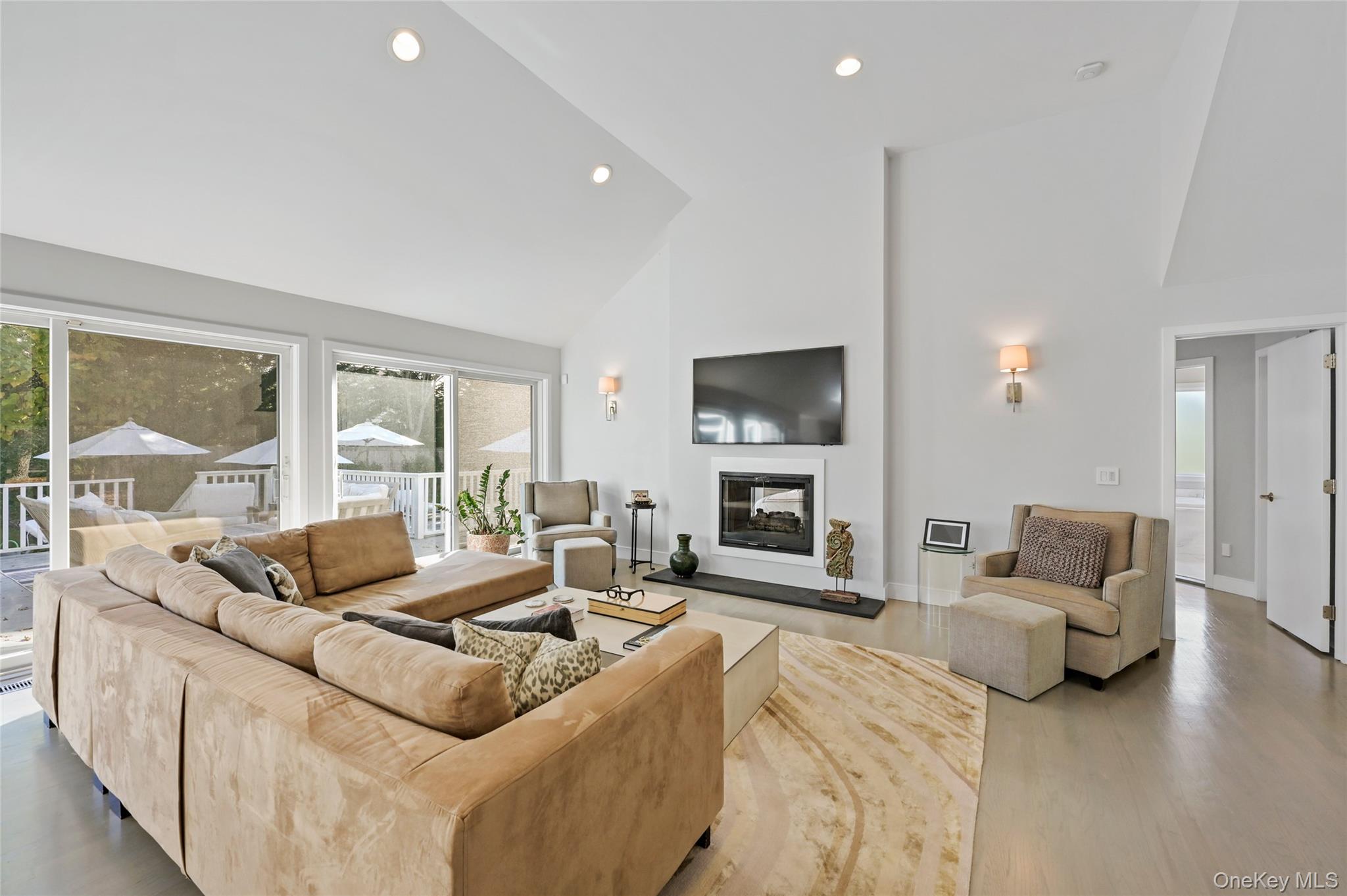 6 Bridle Path Westhampton Beach, NY 11978 - Photo 5 of 33 a living room with furniture and a flat screen tv