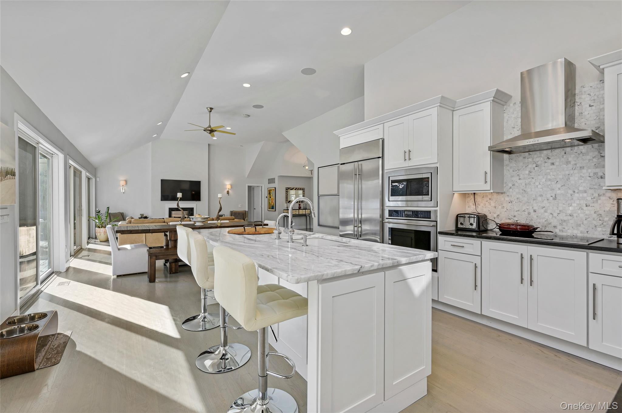 6 Bridle Path Westhampton Beach, NY 11978 - Photo 10 of 33 a kitchen with stainless steel appliances kitchen island granite countertop a sink and cabinets