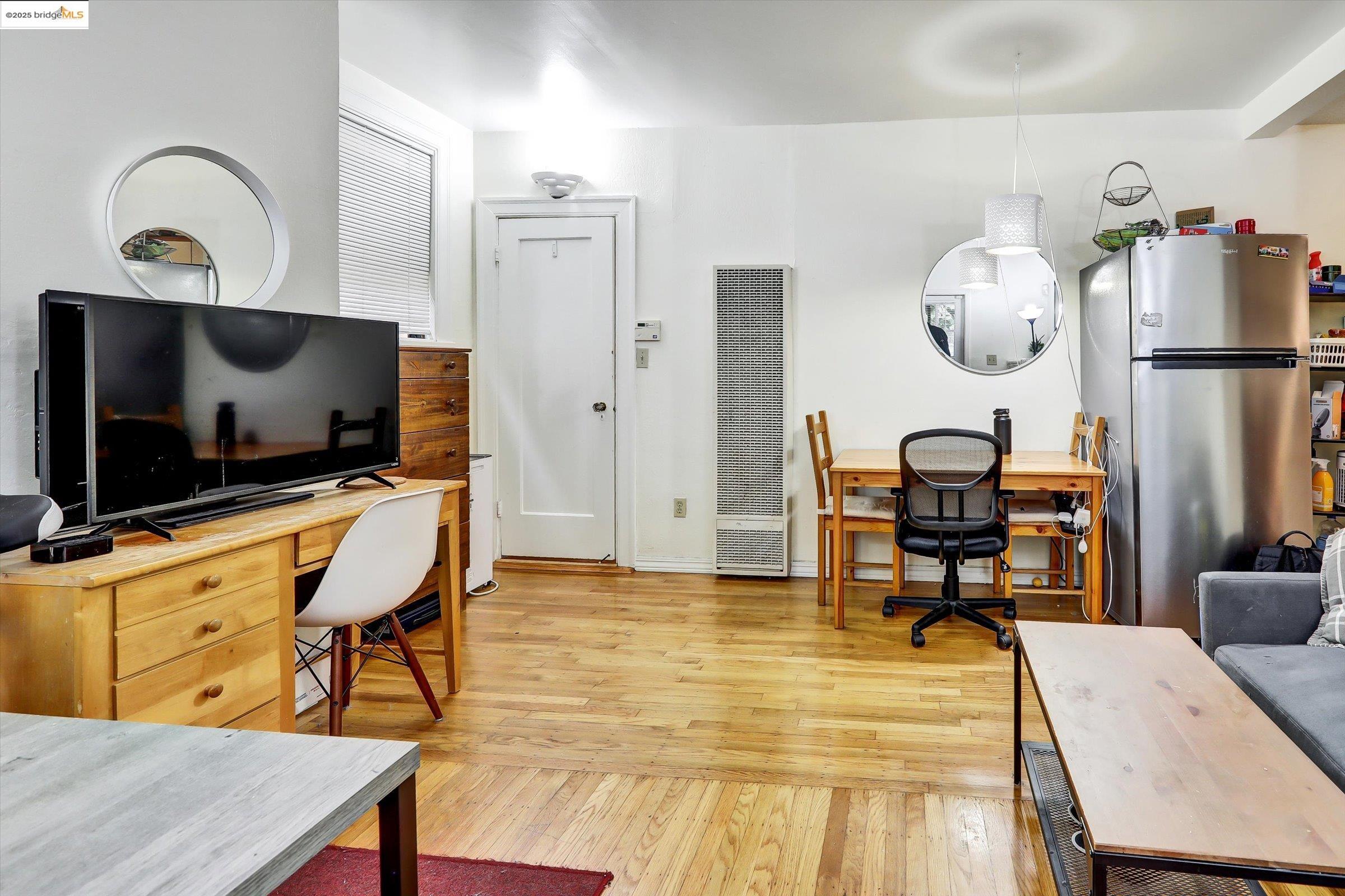 2117 Delaware Street, Unit B Berkeley, CA 94709 - Photo 6 of 14 a living room with furniture a flat screen tv and kitchen view