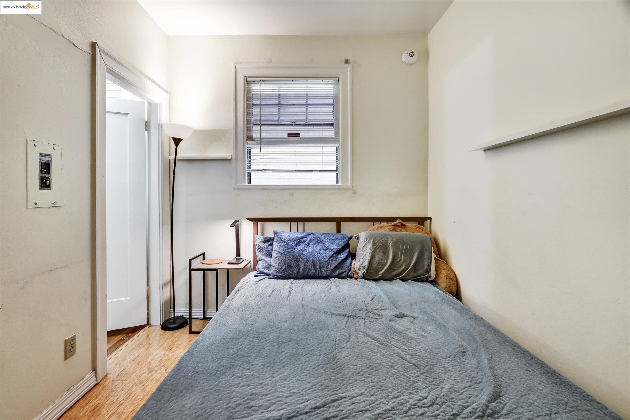 2117 Delaware Street, Unit B Berkeley, CA 94709 - Photo 7 of 14 a bedroom with a bed and wooden floor