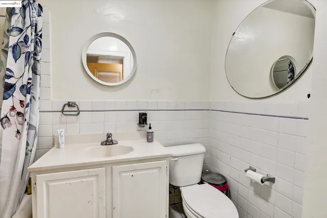 a bathroom with a toilet a sink and a mirror