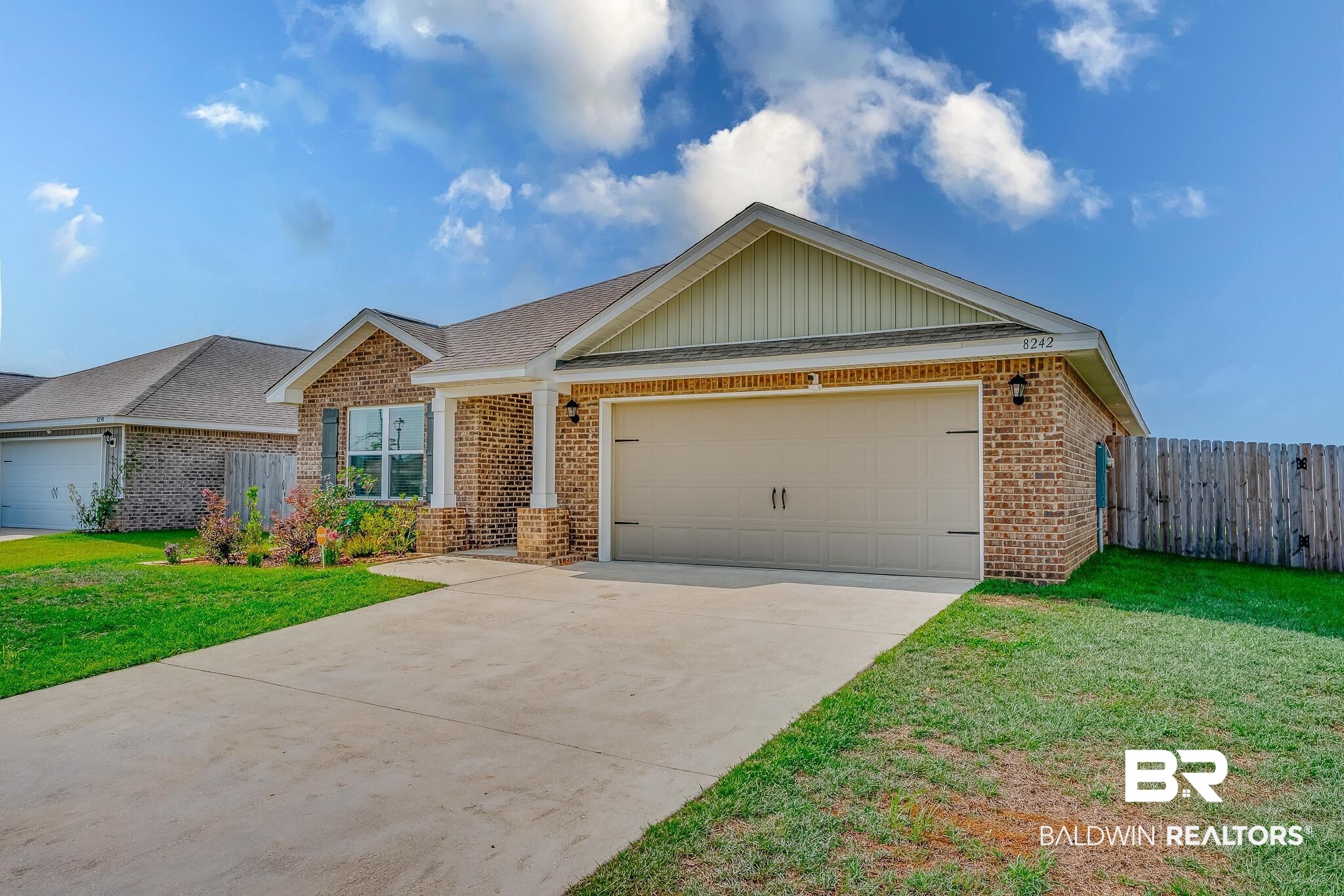 8242 Sycamore Way Semmes, AL 36575 - Photo 4 of 43 View of front of home with brick siding, driveway, a garage, board and batten siding, and roof with shingles
