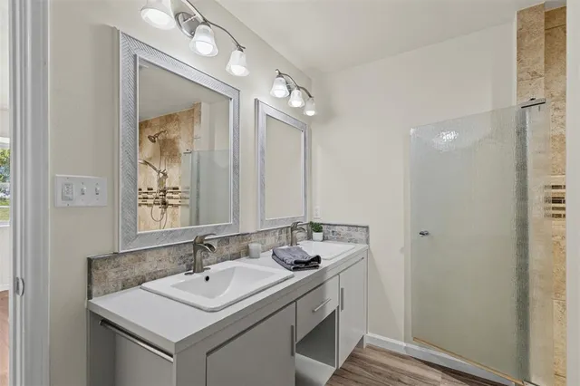a bathroom with a sink vanity and a mirror