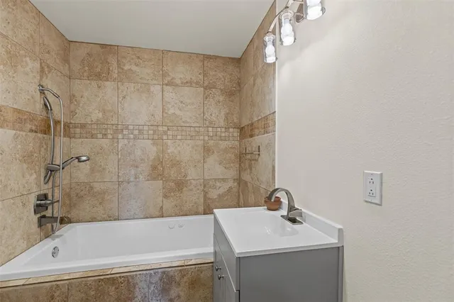 a bathroom with a bathtub and a sink