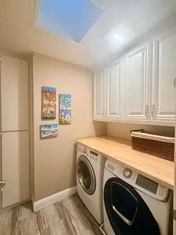 a view of a big yard with a fountain and large trees