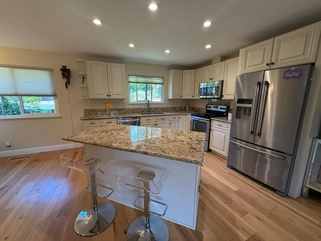 a bathroom with a tub a sink and a mirror