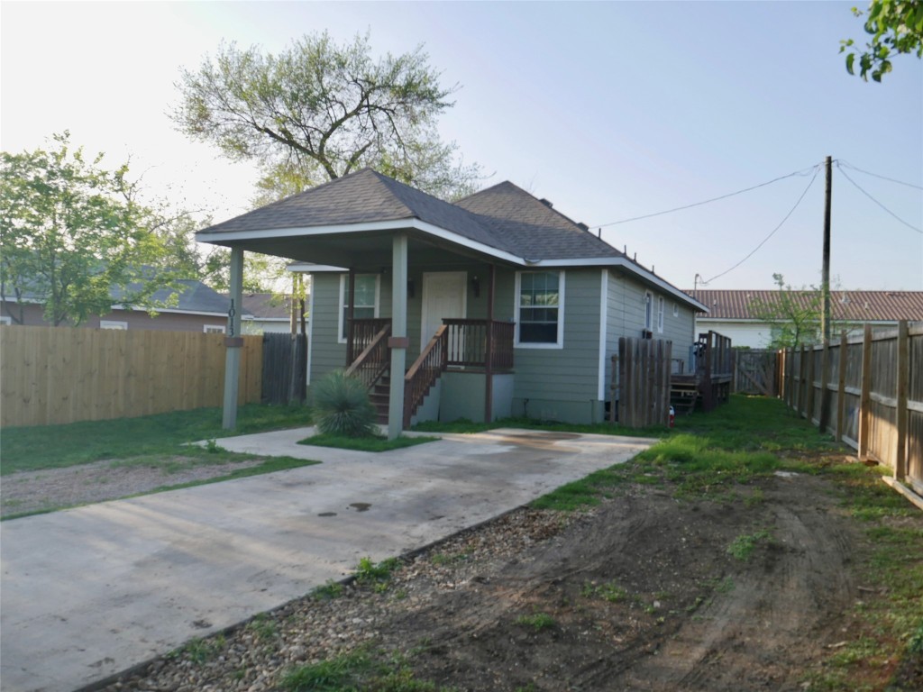 1013 Price Street Taylor, TX 76574 - Photo 2 of 12 a front view of a house with yard and tree s