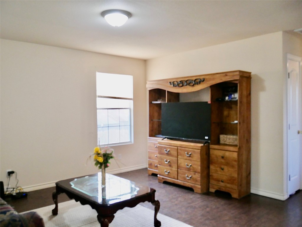 1013 Price Street Taylor, TX 76574 - Photo 3 of 12 a living room with furniture and flat screen tv