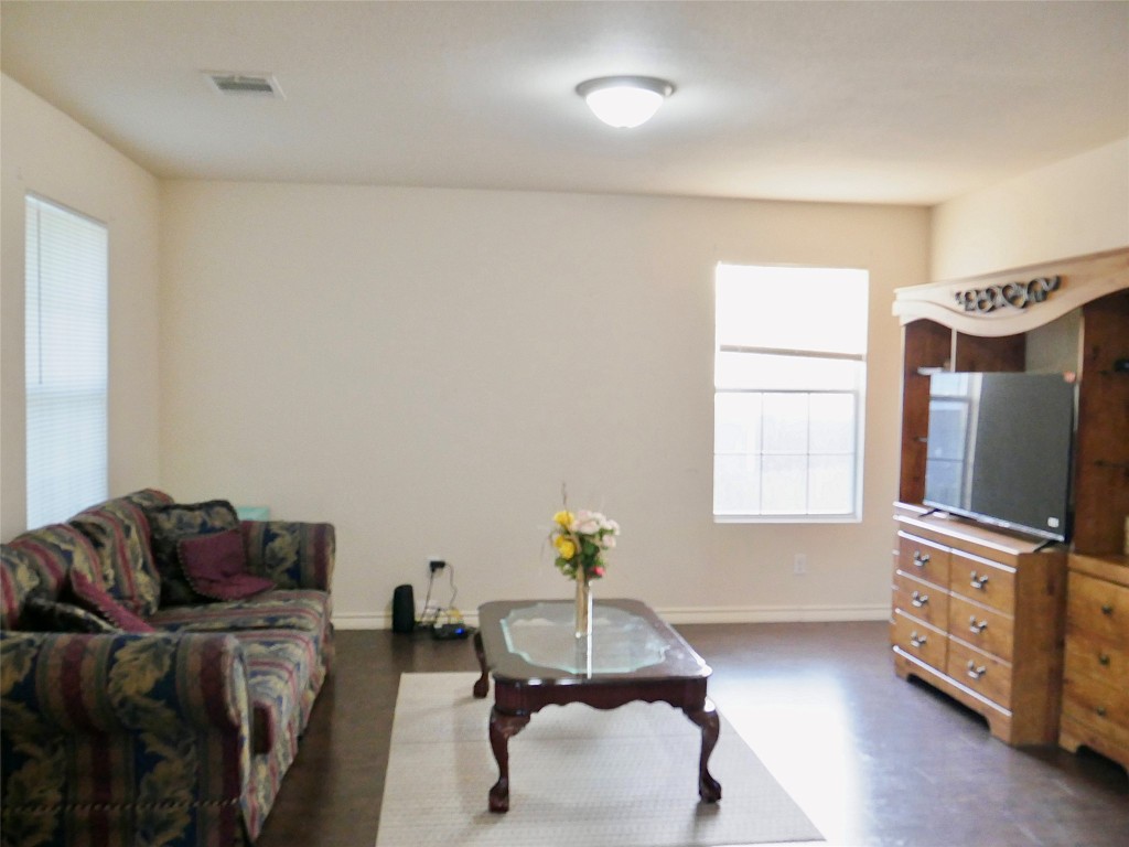 1013 Price Street Taylor, TX 76574 - Photo 4 of 12 a living room with furniture and a flat screen tv