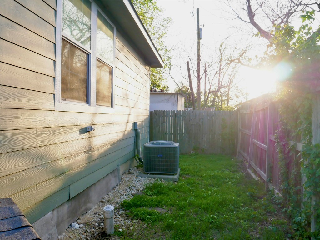 1013 Price Street Taylor, TX 76574 - Photo 8 of 12 a view of a backyard with potted plants