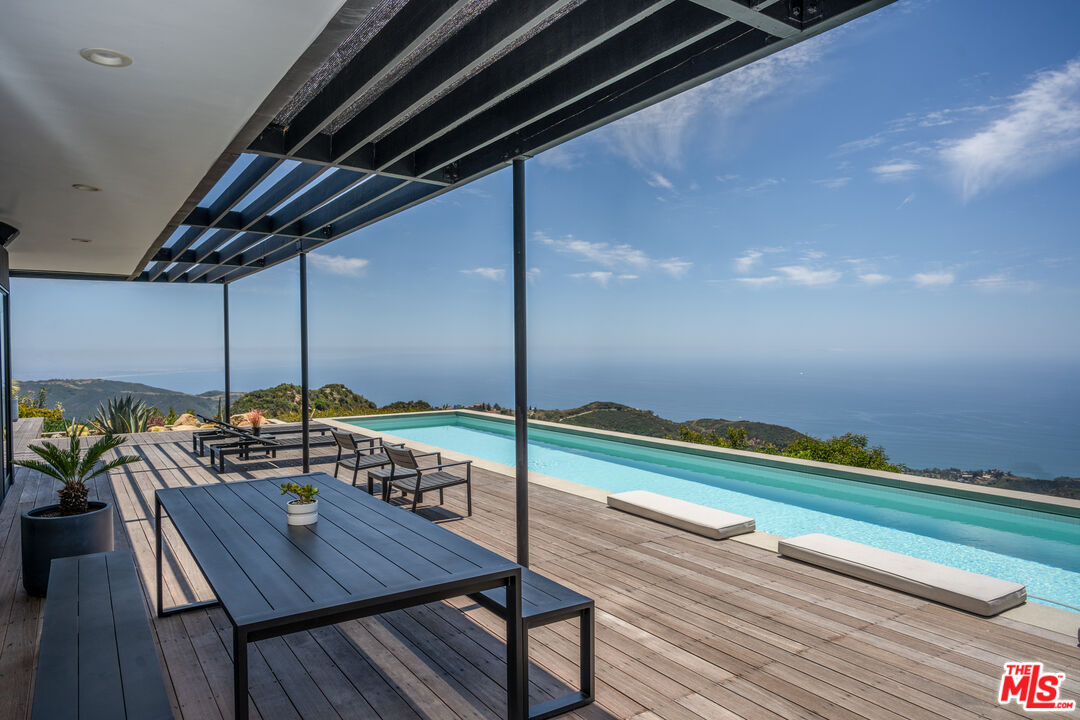 24311 Piuma Road Malibu, CA 90265 - Photo 5 of 28 a view of a tables and chairs in patio