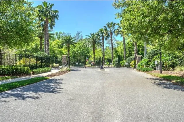 a view of a street with a building and trees in the background