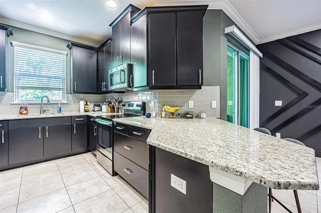 a kitchen with a sink refrigerator and cabinets