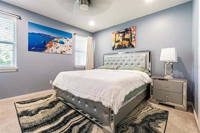 a bedroom with a bed and painting on the wall