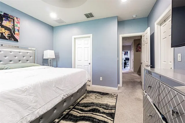 a spacious bedroom with a bed and a walk in closet