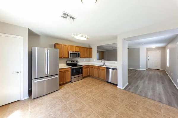 a kitchen with granite countertop a refrigerator and a sink