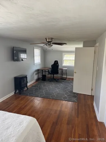 a view of a livingroom with furniture and a window