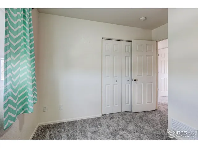 a view of an empty room and a window