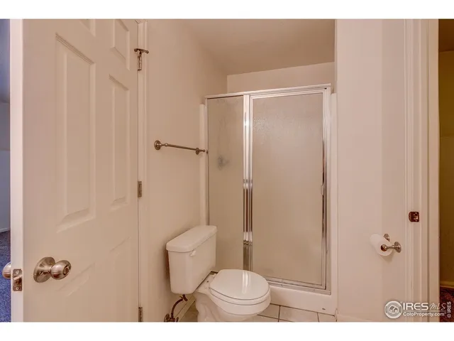a bathroom with a toilet a sink and shower