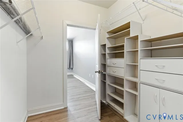 a view of walk in closet with empty racks